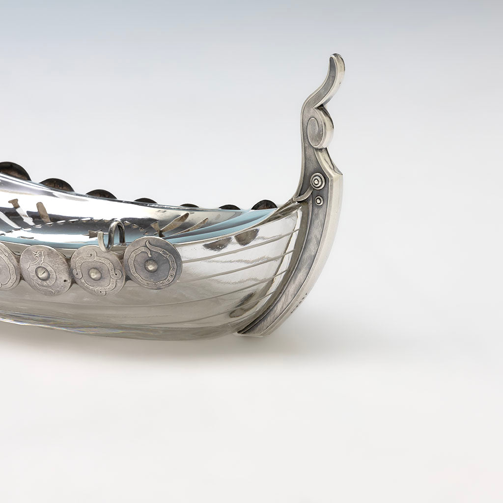 Dragon tail of JE Caldwell(retailer) American Aesthetic Movement Sterling and Glass Viking Ship Form Butter Dish, c. 1880s