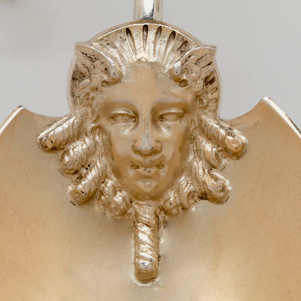 Close up of the mask on the Gorham Antique Coin Silver Figural Serving Scoop, Providence, RI, c. 1867