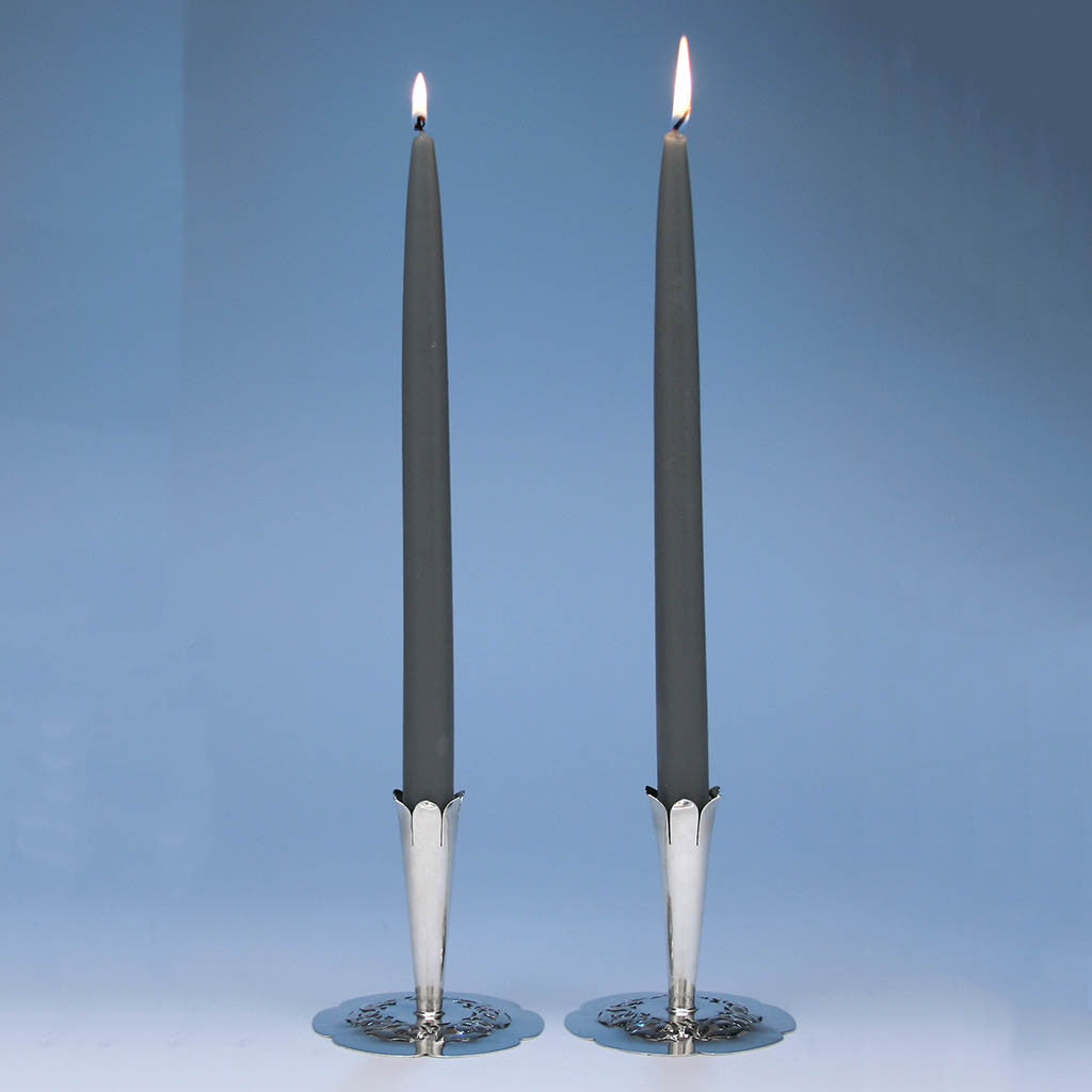  A beautiful and rare form, these arts &amp; crafts candlesticks are wonderfully hammered, pierced and chased with floral decoration. The petal-shaped bases are slightly domed with rising candleholders also in the forms of blossoming flowers. Panis is known for his floral pierced silver jewelry and these are wonderful examples of his famous style and technique in holloware.  Stavre Gregor Panis is listed in The Society of Arts &amp; Crafts, Boston Exhibition Record 1897-1927 by Karen Evans Ulehla. He is listed as a