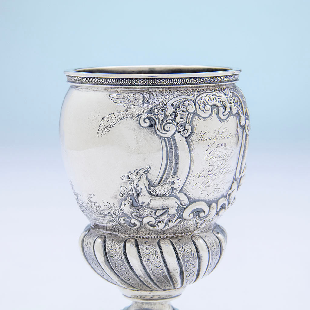 Shield left of Adolphe Himmel Coin Silver &#39;Hook &amp; Ladder Co 1&#39; Presentation Trophy Goblet, New Orleans, LA, 1857