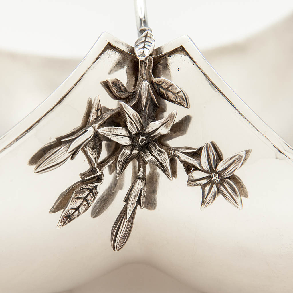 Floral detail on the Gorham Antique Sterling Silver Cake Basket, Providence, RI, 1870, retailed by Bailey &amp; Co., Philadelphia